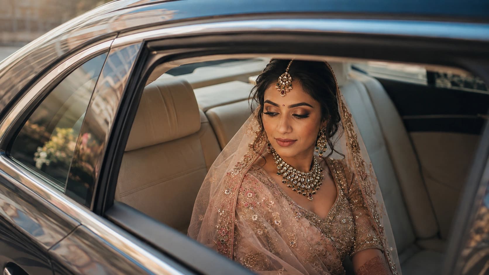 Indian bride seated inside a luxury wedding car
