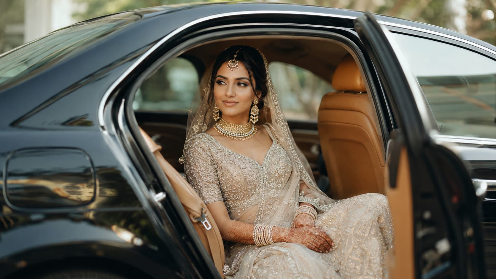 Indian bride seated inside a black luxury wedding car
